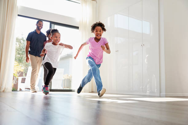 istock Excited Family Exploring New Home On Moving Day 992108674