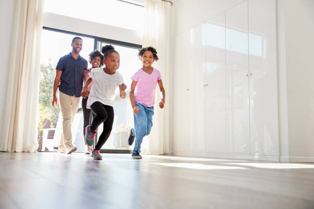 istock Excited Family Exploring New Home On Moving Day 992108682