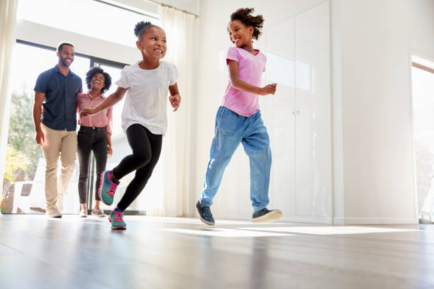 istock Excited Family Exploring New Home On Moving Day 992108700