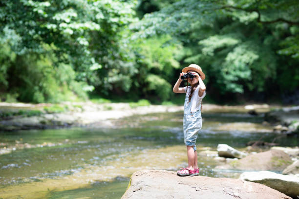 istock Girl playing in the river 992111266