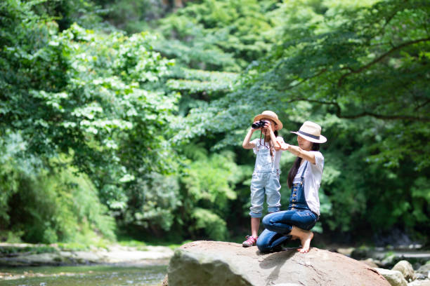 Mother and daughter playing in the river