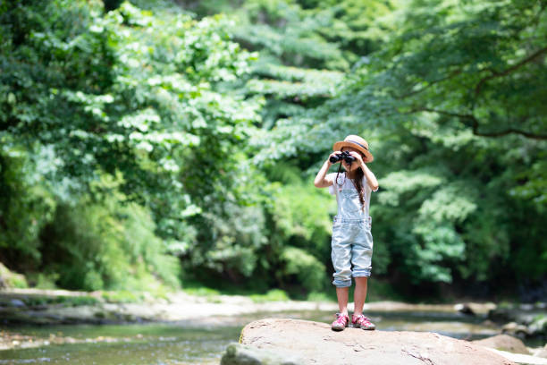 istock Girl playing in the river 992111324