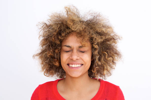 istock Close up embarrassed young woman smiling with eyes closed 992112134
