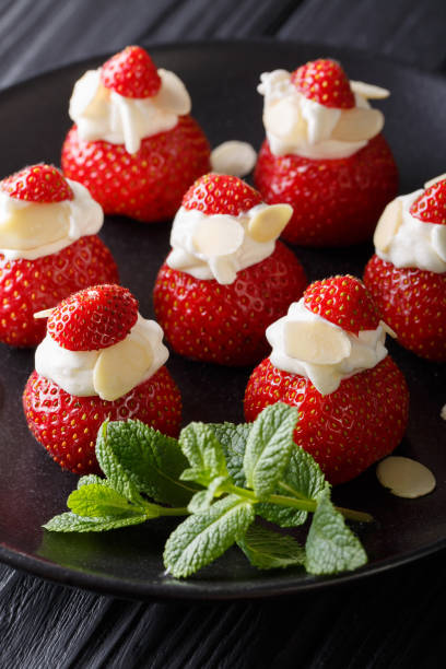istock Strawberry dessert with whipped cream, almonds and mint closeup. vertical 992118372