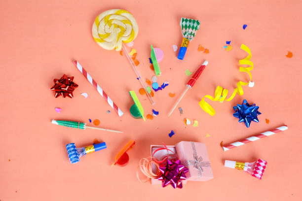 istock Red gift box with party confetti, streamers and noisemakers 992118786