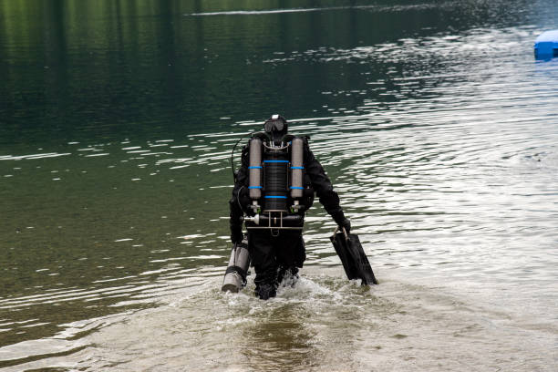 Close view on the diver entering the lake in high Alps Austria