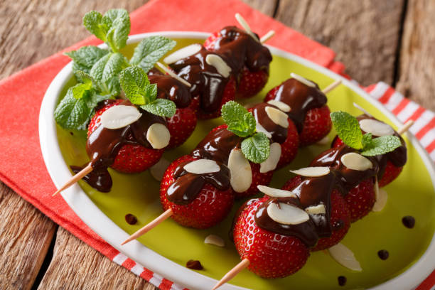 istock Summer strawberries dessert with chocolate, mint and almonds. Horizontal 992124444