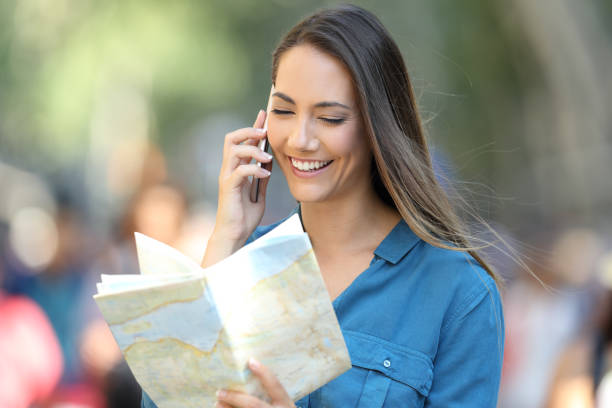 istock Happy tourist asking information on phone 992125044