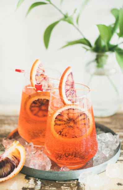 istock Spritz cocktail drink with orange and ice in glasses 992125174