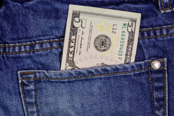 Five dollars banknote in the pocket of blue jeans Five dollars banknote in the pocket of blue jeans five dollar bill stock pictures, royalty-free photos & images