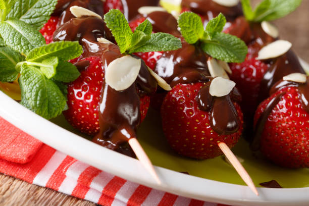 istock Strawberry on skewers with chocolate and almonds macro. horizontal 992128330