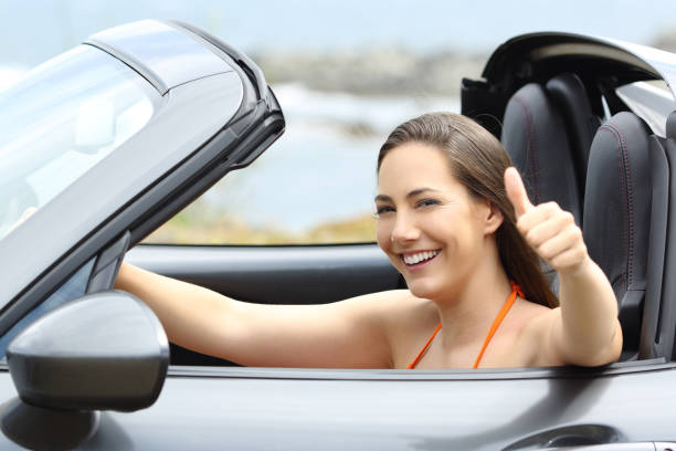 istock Convertible car driver with thumbs up 992128786