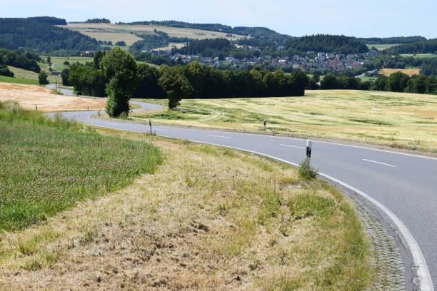 istock twisting small country road 992134420