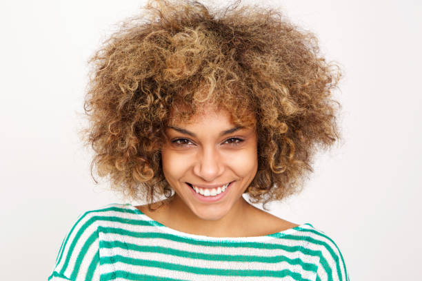 istock smiling young african woman against white background 992138140