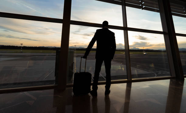 istock Businessman Looking At Sunset Through Airport Window 992156780