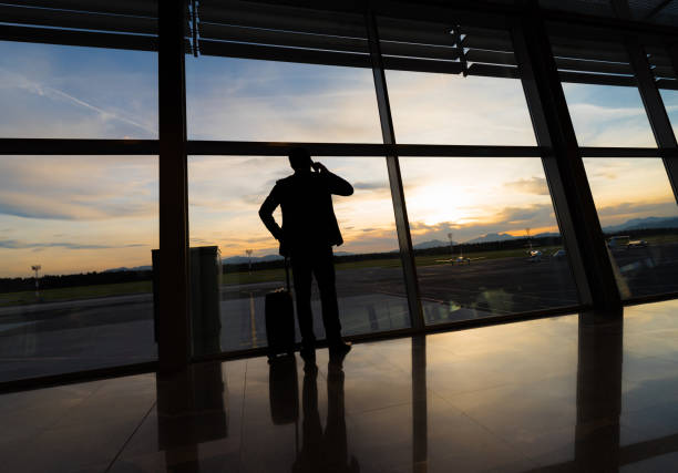 istock Businessman Looking At Sunset Through Airport Window 992156834