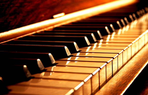 Golden Piano Keys Wood piano in dramatic gold tones grand piano stock pictures, royalty-free photos & images