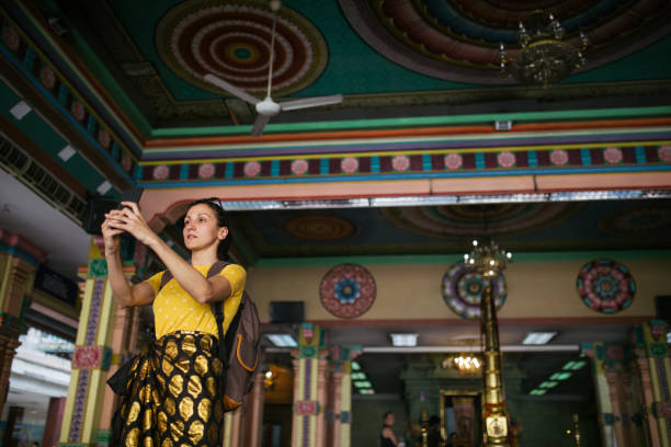 Woman taking a picture of Sri Mahamariamman Temple Young woman taking a picture of Sri Mahamariamman Temple, Kuala Lumpur, Malaysia beautiful multi colored tranquil scene enjoyment stock pictures, royalty-free photos & images