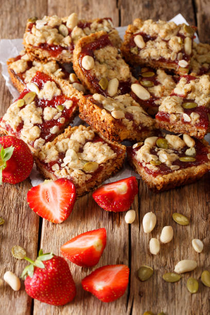 istock Granola bars with strawberry jam, seeds and nuts close-up. vertical 992168456