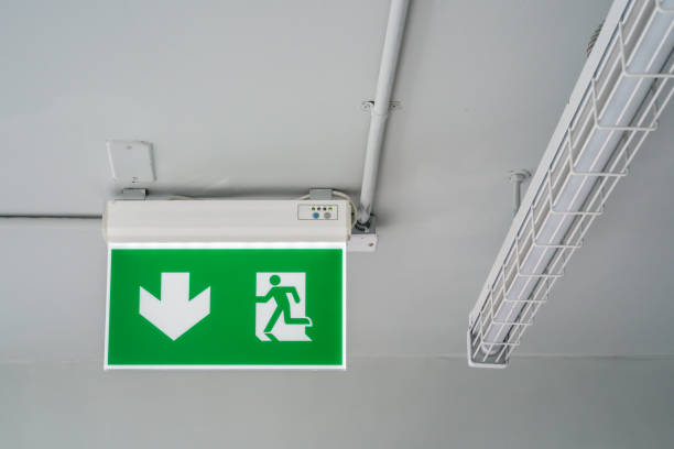 istock Green emergency exit sign. Direction to the escape way. 992178038