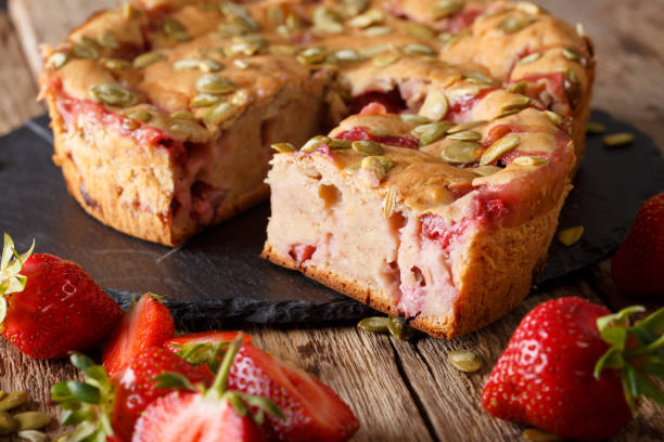istock Fruit banana bread with strawberries and pumpkin seeds close-up on a table. Horizontal 992183946