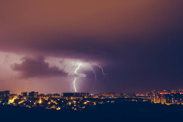 istock Thunderstorms vivid blue sky and lightnings above night city 992184416
