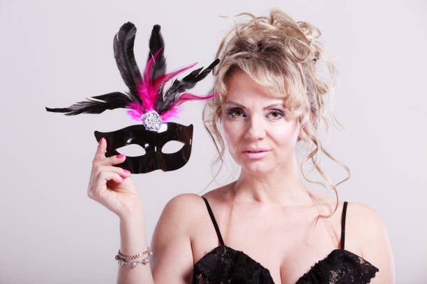 istock Woman middle aged holds carnival mask. 992193078