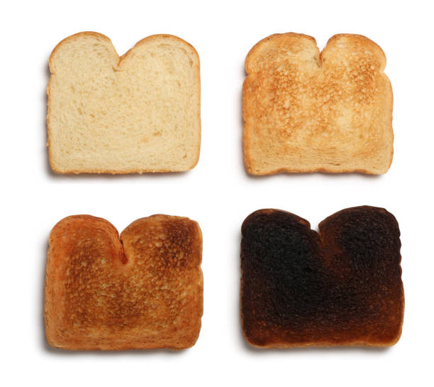 istock Four Stages of Burnt Toast Isolated on White Background 992212384