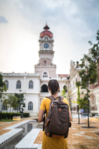 istock Young woman with backpack visiting the Sultan Abdul Samad Building 992220896