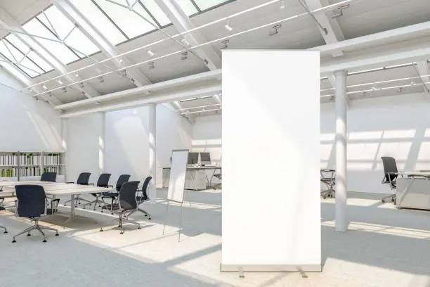 Blank roll up banner stand in loft office with clipping path around banner. 3d illustration