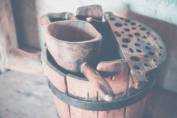 Old wooden barrel and scoop. Wooden barrel, trough, scoop in old country house.