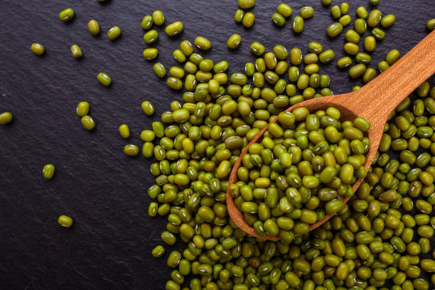 istock fresh Mung beans on a dark stone background 992277534
