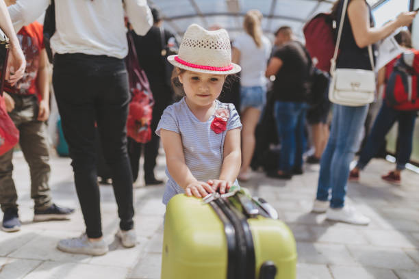 Young and beautiful toddler girl, boarding a plane on a airport.