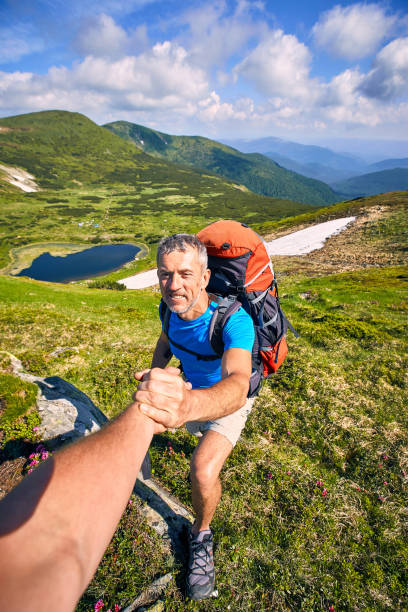 istock A helping hand high in the mountains in the summer hike. 992291460