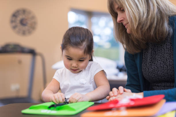 istock Occupational therapist works with a young ethnic girl 992299922