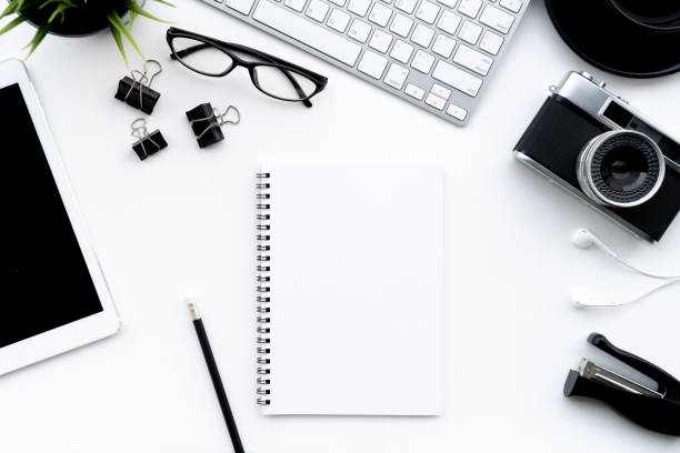 istock Flat lay of top view modern white desk work table with computer laptop,retro film camera and stationary in home office includes copyspace for add text or graphic 992312534