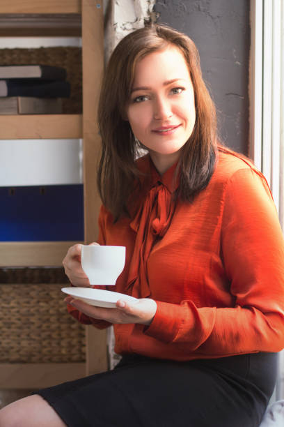 istock Business lady drinking coffee in office 992328668