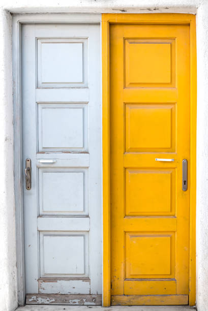 istock Rustic white and yellow doors of Greek island 992330034