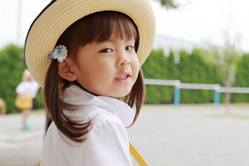 Japanese girl in uniform in kindergarten yard in summer (3 years old)