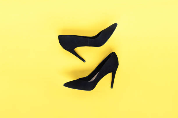 negro moda elegante zapatos de tacones altos sobre fondo amarillo. fondo moderno endecha plana, alta vista. ver blog la moda. - shoe single object isolated red fotografías e imágenes de stock