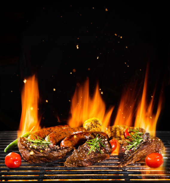 istock Various meat being grilled, isolated on black 992346494