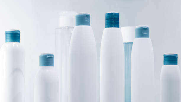 istock Several different close up of a white and turquoise blue designer plastic bottle for cosmetics and perfumery or for other liquids 992346894
