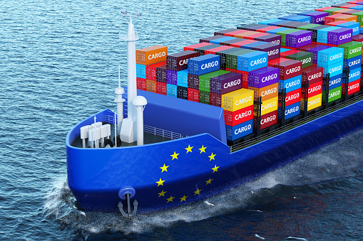 The European Union freighter ship with cargo containers sailing in ocean, 3D rendering