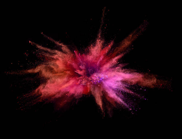istock Explosion of coloured powder on black background 992349008