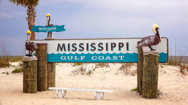 Welcome to Mississippi Gulf Coast Sign on Beach Welcome to Mississippi Gulf Coast sign on sandy beach in Gulfport mississippi stock pictures, royalty-free photos & images