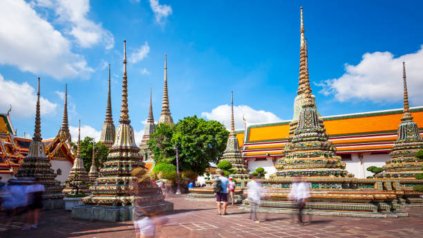 istock Buddhist Stupas at Wat Pho in Bangkok, Thailand (blurred faces) 992352704