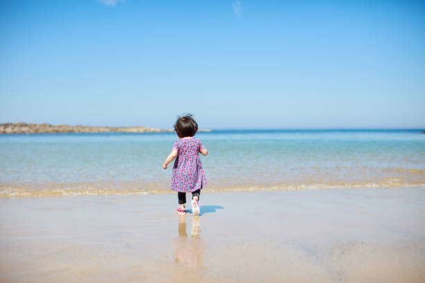 baby girl playing at summer beach