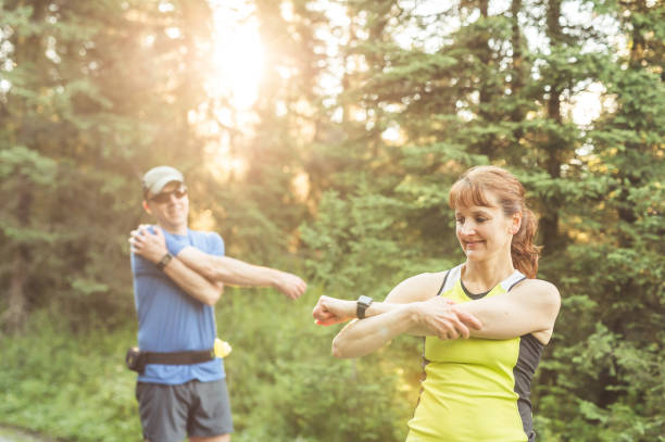istock Middle-aged couple trail running in the forest 992420276