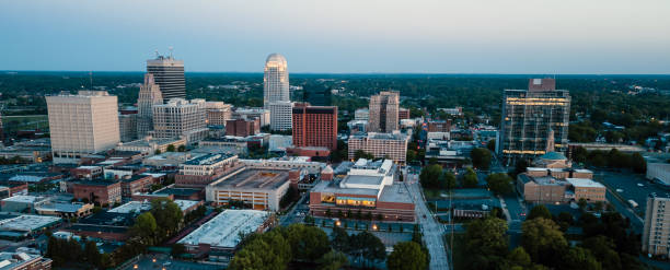 istock Aerial View as Night Falls on the Downtown City Skyline at Winston-Salem 992425188