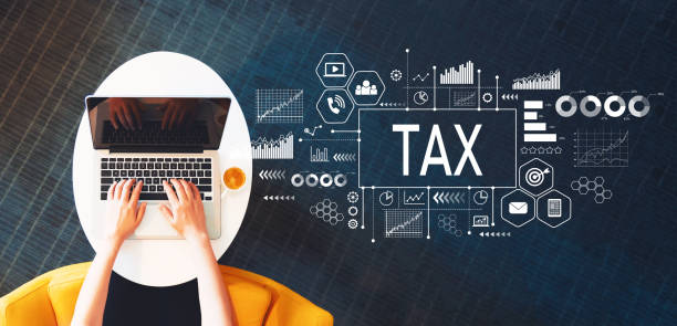 istock Tax with person using a laptop 992429208